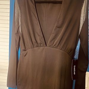 Never worn black low plunge dress with silver fringes. Very nice on.